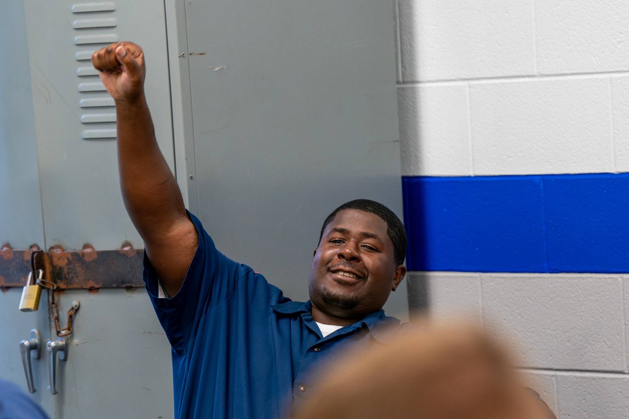 A student raising their hand in the classroom